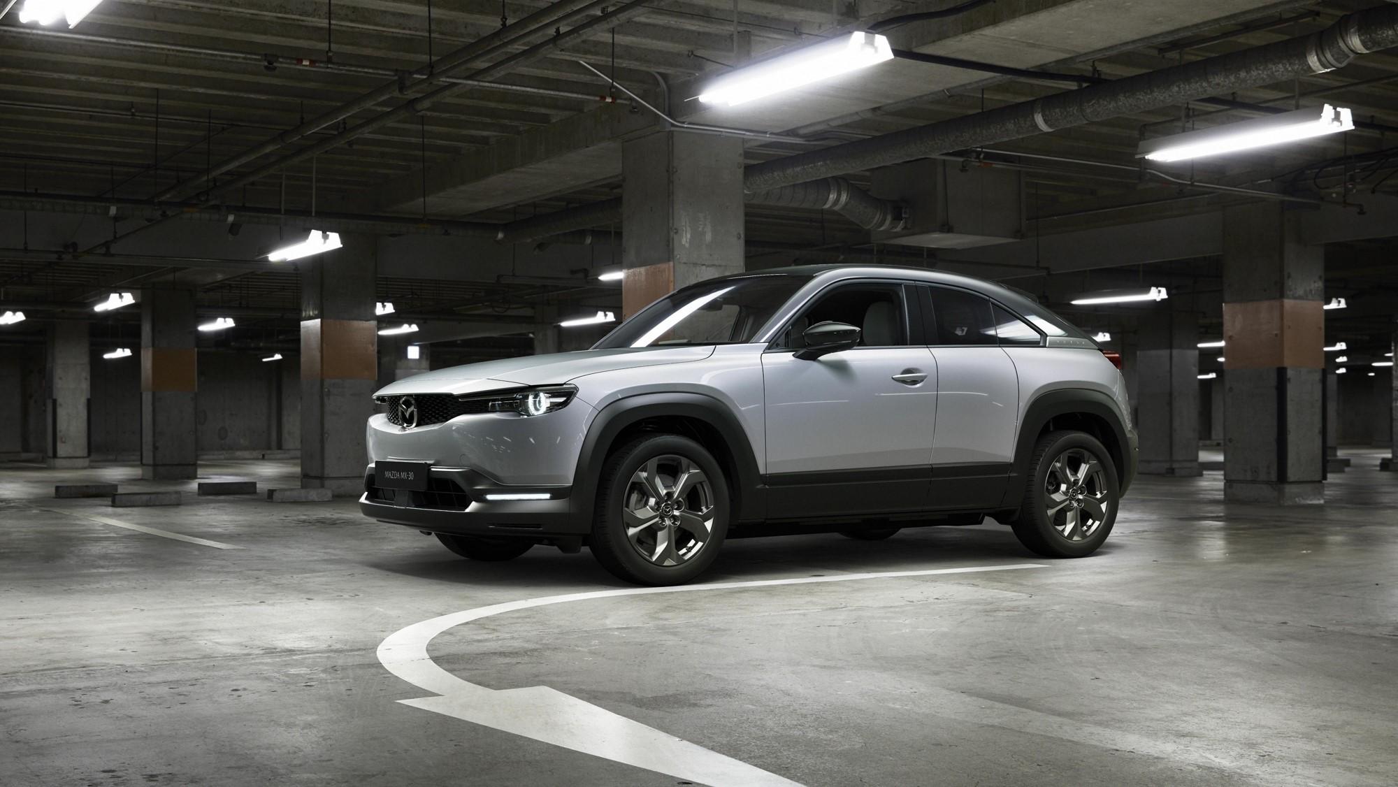A silver Mazda SUV  parked in an underground parking lot.